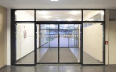 How do automatic sliding doors enhance the security of buildings?