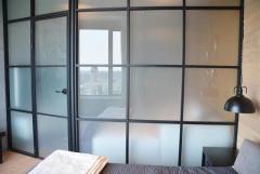 What is the modern appeal of frosted glass partitions?